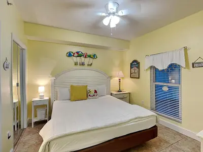 a bedroom with a large white bed and a window at Majestic Beach Towers I #405 in Panama City Beach