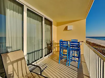 a balcony with two blue chairs and a balcony with the beach at Majestic Beach Towers I #405 in Panama City Beach