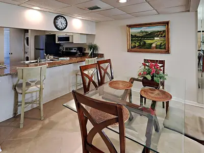 a kitchen and dining room with a table and chairs at Edgewater Tower II 509 in Panama City Beach