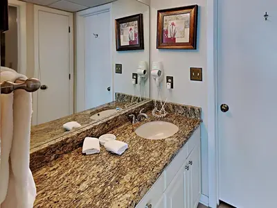 a bathroom counter with a sink and a mirror at Edgewater Tower II 509 in Panama City Beach