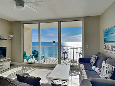 a living room with a couch and a view of the ocean at Majestic Beach Towers I #1410 in Panama City Beach