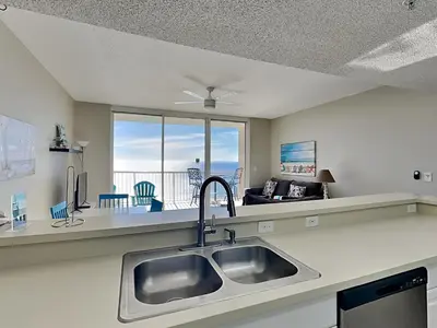 a kitchen with a sink and a view of the ocean at Majestic Beach Towers I #1410 in Panama City Beach