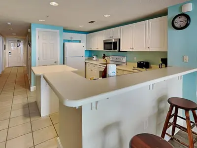 a kitchen with white cabinets and a counter top at Majestic Beach Towers II #1204 in Panama City Beach