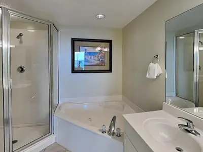 a bathroom with a tub and a sink and a shower at Majestic Beach Towers II #1204 in Panama City Beach