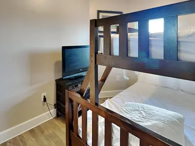 a bedroom with a bunk bed with a computer and a laptop at Majestic Beach Towers II #1204 in Panama City Beach