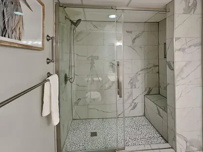 a shower with a glass door in a bathroom at Emerald Beach #1927 in Panama City Beach