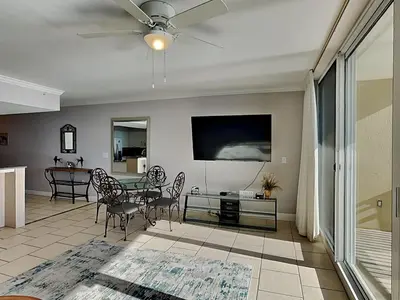 a living room with a table and chairs at Emerald Beach #1927 in Panama City Beach