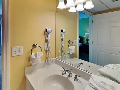 a bathroom with a sink and a large mirror at Emerald Beach #1825 in Panama City Beach