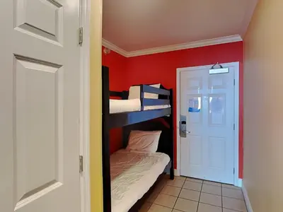 a room with two bunk beds and a door at Emerald Beach #1825 in Panama City Beach