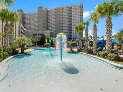 a pool with a fountain in front of a resort at Emerald Beach #1825 in Panama City Beach
