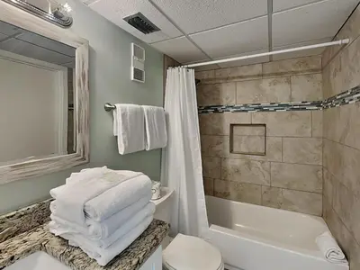 a bathroom with a tub and a toilet and a shower at Edgewater Tower II 809 in Panama City Beach