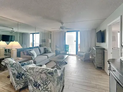 a living room with a couch and a table at Edgewater Tower II 809 in Panama City Beach