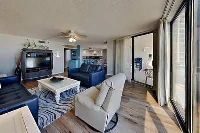 a living room with a couch and a tv at Edgewater Tower Iii 213 in Panama City Beach