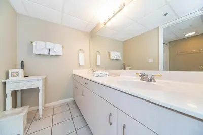a bathroom with a sink and a large mirror at Long Beach Resort Tower IV #407 in Panama City Beach