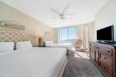a bedroom with two beds and a flat screen tv at Long Beach Resort Tower IV #407 in Panama City Beach
