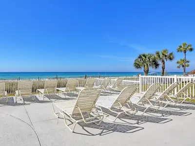 a group of chairs sitting on the beach at Long Beach Resort Tower IV #407 in Panama City Beach