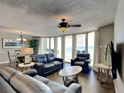 a living room with a couch and a ceiling fan at Long Beach Resort Tower I #503 in Panama City Beach