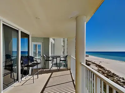 a balcony with chairs and a table on the beach at Long Beach Resort Tower I #503 in Panama City Beach