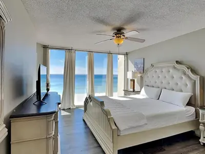 a bedroom with a bed and a ceiling fan at Long Beach Resort Tower I #503 in Panama City Beach