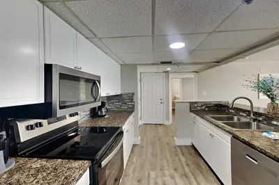 a kitchen with a sink and a stove top oven at Long Beach Resort Tower II #503 in Panama City Beach