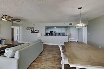 a living room with a couch and a dining room table at Long Beach Resort Tower II #503 in Panama City Beach