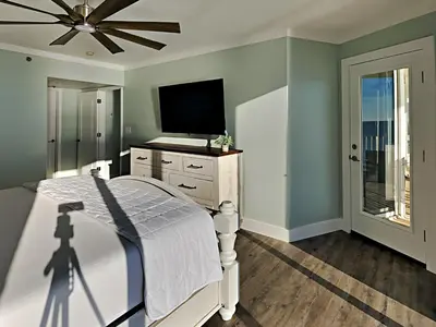 a bedroom with a bed and a flat screen tv at Long Beach Resort Tower I #900 in Panama City Beach