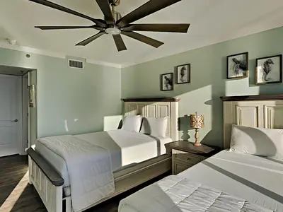 a bedroom with two beds and a ceiling fan at Long Beach Resort Tower I #900 in Panama City Beach