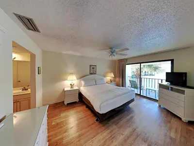 a large bedroom with a bed and a balcony at Edgewater Villa #814 in Panama City Beach
