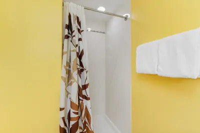 a bathroom with a shower with a shower curtain at Shores of Panama #1425 in Panama City Beach