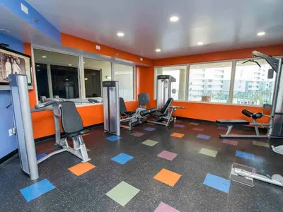 a gym with several treadmills and chairs in a room at Shores of Panama #1425 in Panama City Beach