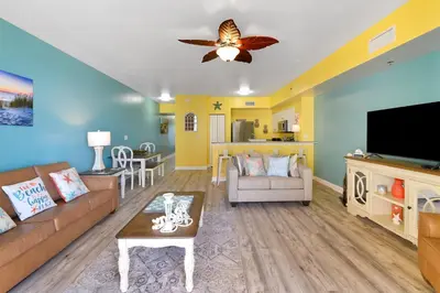 a living room with a couch and a tv at Shores of Panama #1425 in Panama City Beach