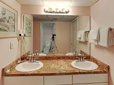 a bathroom with three sinks and a large mirror at Long Beach Resort Tower II #702 in Panama City Beach