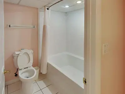 a bathroom with a toilet and a bath tub at Long Beach Resort Tower II #702 in Panama City Beach
