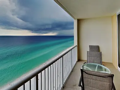 two chairs on a balcony looking out at the ocean at Majestic Beach Towers I #2005 in Panama City Beach