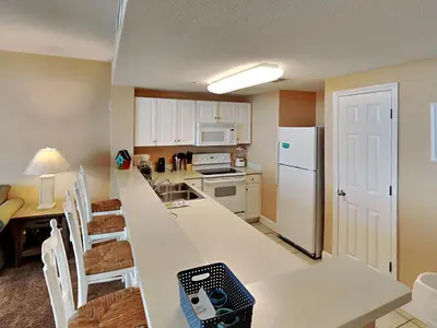 a kitchen with a long counter top in a room at Majestic Beach Towers I #2005 in Panama City Beach