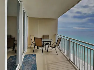 a balcony with a table and chairs and the ocean at Emerald Beach #1934 in Panama City Beach