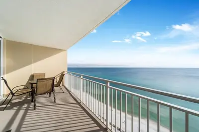 a balcony with a table and chairs and the ocean at Emerald Beach #1934 in Panama City Beach