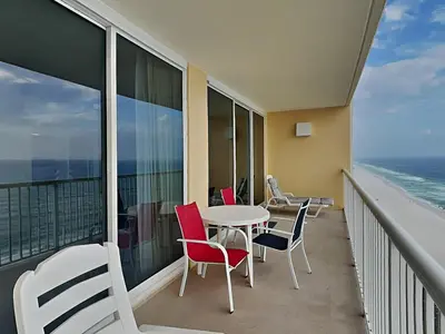 a balcony with a table and chairs and the ocean at Majestic Beach Towers I #1703 in Panama City Beach