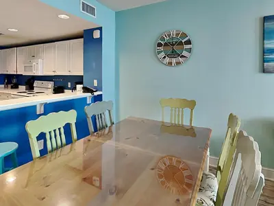 a dining room and kitchen with a table and chairs at Majestic Beach Towers II #1106 in Panama City Beach