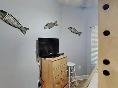 a room with a tv and fish decals on the wall at Majestic Beach Towers II #1106 in Panama City Beach