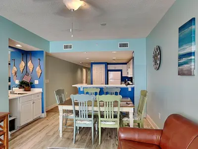 a kitchen and dining room with a table and chairs at Majestic Beach Towers II #1106 in Panama City Beach