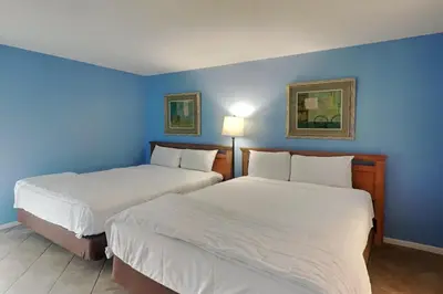two beds in a room with blue walls at Edgewater Tower III #302 in Panama City Beach