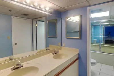 a bathroom with two sinks and a mirror at Edgewater Tower III #302 in Panama City Beach