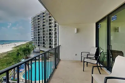 a balcony with chairs and a view of the beach at Edgewater Tower III #302 in Panama City Beach