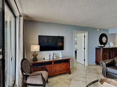 a living room with a flat screen tv on a wall at Edgewater Tower III #212 in Panama City Beach