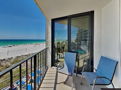 a balcony with chairs and a view of the beach at Edgewater Tower III #212 in Panama City Beach