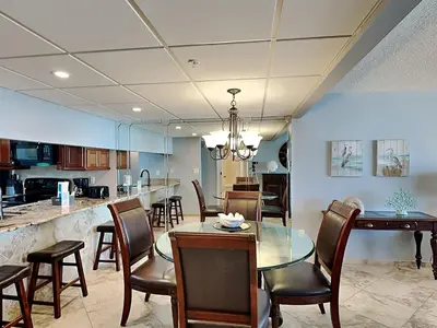 a dining room and kitchen with a table and chairs at Edgewater Tower III #212 in Panama City Beach