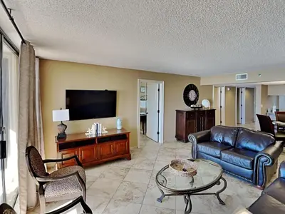 a living room with a couch and a tv at Edgewater Tower III #212 in Panama City Beach