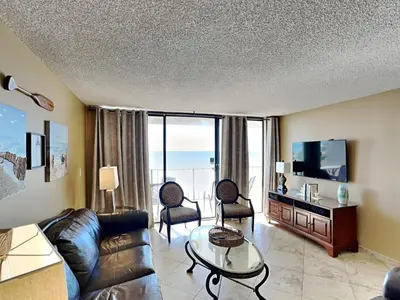 a living room with a couch and a tv at Edgewater Tower III #212 in Panama City Beach