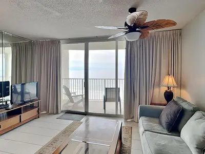 a living room with a couch and a ceiling fan at Long Beach Resort Tower III #602 in Panama City Beach